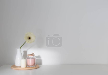 Photo for Gerber with candles on white shelf - Royalty Free Image