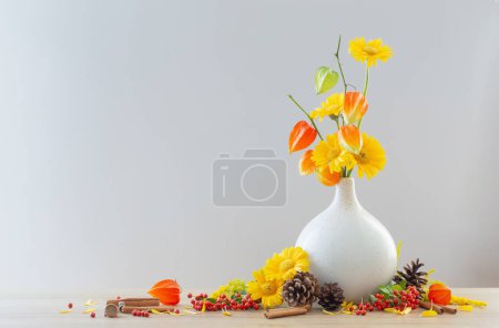 Photo for Autumnal still life with flowers, cones, berries on wooden shelf - Royalty Free Image