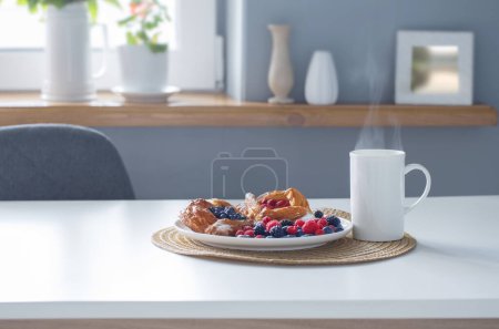 Photo for Dessert with berries  and hot drink on white table - Royalty Free Image