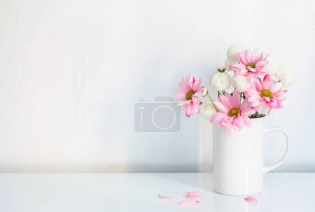 Photo for White and pink  chrysanthemums in vintage cup on white background - Royalty Free Image