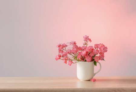 Photo for Pink roses in ceramic vase on pink background - Royalty Free Image