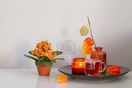 Photo for Autumnal still life with flowers and candles, on white table - Royalty Free Image
