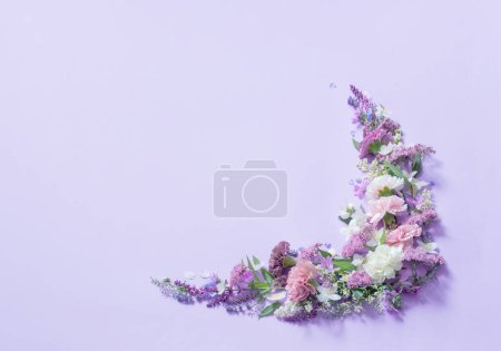 Photo for Beautiful summer flowers on light purple background - Royalty Free Image