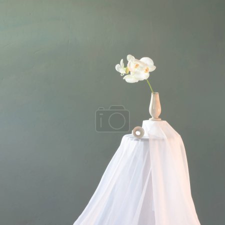 Photo for Broken vase with white orchid on dark green wall - Royalty Free Image