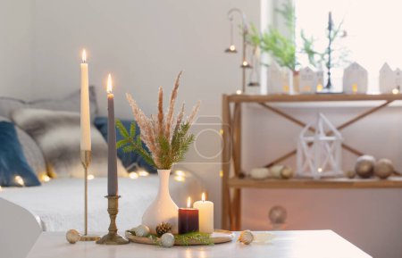 Photo for Burning candles with christmas decor in white cozy interior - Royalty Free Image