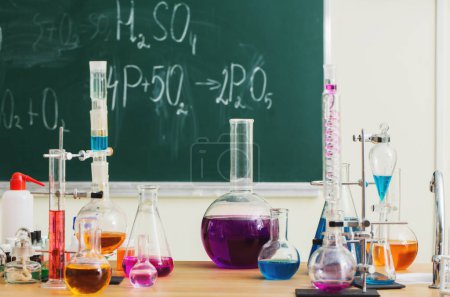Photo for Glass flasks with multi-colored liquids at the chemistry lesson - Royalty Free Image
