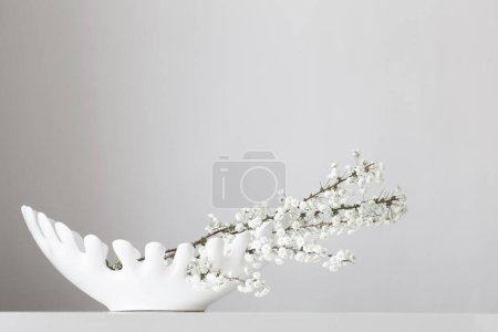 Photo for White spring flowers in ceramic white  vase on white background - Royalty Free Image