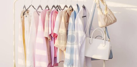 Photo for Female   summer wardrobe in  white room - Royalty Free Image