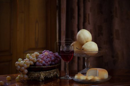 Photo for Still life with fruits and cheese and glass of red vine on wooden background - Royalty Free Image