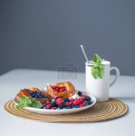 Photo for Cup of tea with fruit dessert - Royalty Free Image