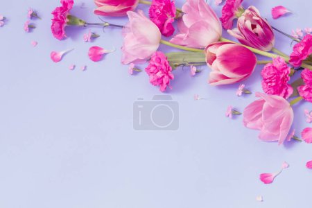 Photo for Beautiful spring flowers on purple  background - Royalty Free Image