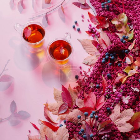 Foto de Dos tazas de té rosa fondo de otoño con hojas y tejer - Imagen libre de derechos