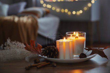 Photo for Autumn and winter home decor with burning candles - Royalty Free Image