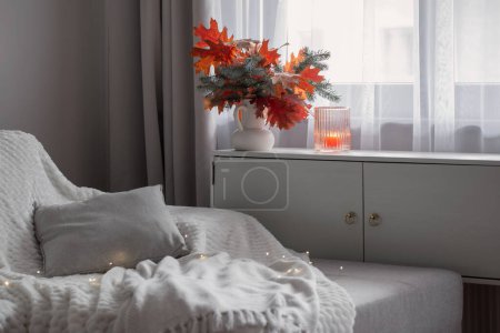 Photo for White modern room with autumn bouquet and pillows on sofa - Royalty Free Image