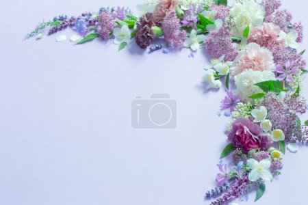 Photo for Beautiful summer flowers on light purple background - Royalty Free Image