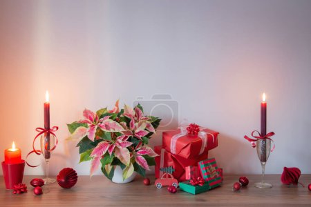 Photo for Pink poinsettia with christmas red  decor on wooden shelf on background gray wall - Royalty Free Image