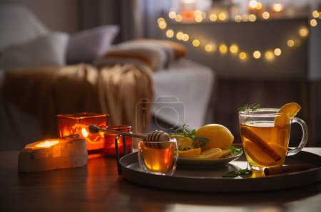 Photo for Cup of tea with lemon and honey on wooden table at home - Royalty Free Image