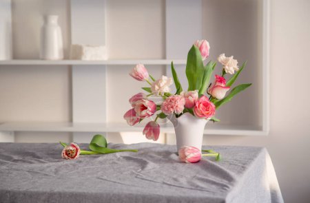 Photo for Pink spring flowers in white ceramic vase in modern home interior - Royalty Free Image