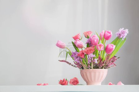 Photo for Pink flowers in vase on background white wall - Royalty Free Image