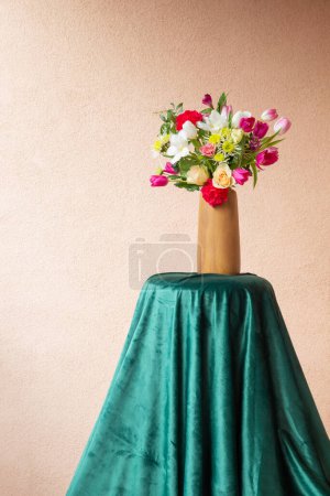 Foto de Hermosas flores en jarrón en la mesa en la pared de fondo - Imagen libre de derechos