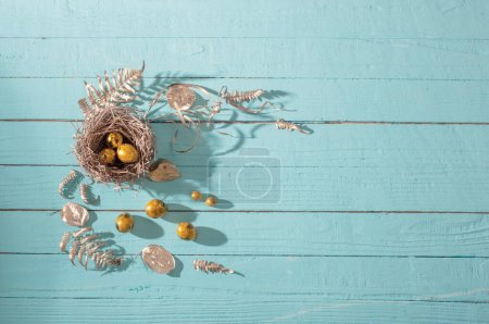 Photo for Easter golden eggs on old blue wooden background - Royalty Free Image