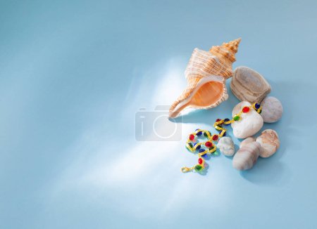 Photo for Modern jjewellery with stones and seashell on blue background - Royalty Free Image