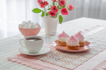 Photo for Cup of coffee with dessert and roses on table - Royalty Free Image