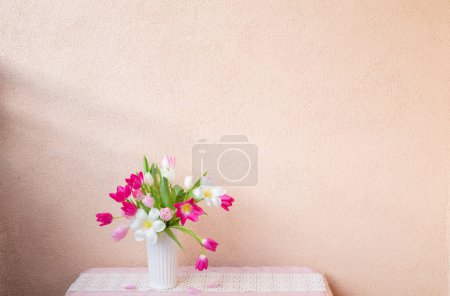 Téléchargez les photos : Tulipes dans un vase sur la table sur le mur de fond - en image libre de droit