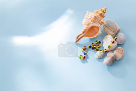 Photo for Modern jjewellery with stones and seashell on blue background - Royalty Free Image