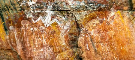 Photo for View of Barrgini, wife of Namondjok, and below a large group of men and women with elaborate ceremonial headdresses, in Kakadu, Northern Territory, Australia - Royalty Free Image