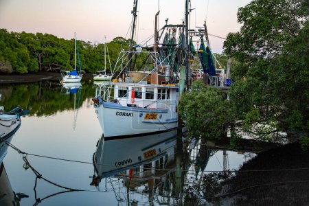 Photo for Seafood trawler moored at the jetty in Cabbage Tree Creek Shorncliffe - Royalty Free Image