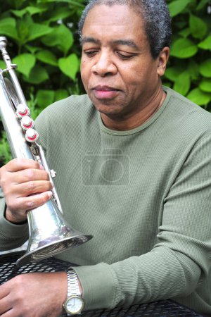 Photo for African american man playing his flugelhorn outside. - Royalty Free Image