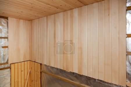 Photo for Interior of a new sauna under construction. Wooden walls and ceiling - Royalty Free Image