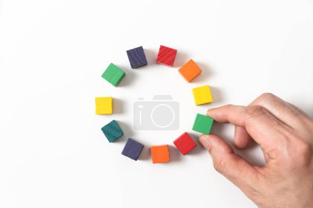 Photo for Concept of data or people centralization and gathering, using circle of colorful wooden blocks representing unity of diverse elements or people isolated on white background. - Royalty Free Image