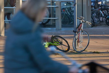 Photo for Bicycles on street in The Netherlands, unfocused motion blurred cyclist moving through the picture - Royalty Free Image
