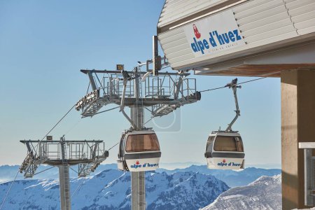 Photo for Alpe dHuez, France - January 20, 2022: Ski cabin lift on steel cables against blue sky, big, popular ski resort with many ski runs - Royalty Free Image