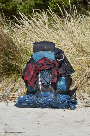 Photo for Huge backpack on the ground at a beach, traveling in New Zealand, backpacking trip - Royalty Free Image