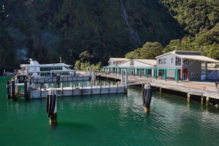 Photo for Milford Sound, New Zealand - March 17, 2016: Milford Sound in Fjordland, New Zealand. Going on a touristic boat ride, ship terminal building and piers for boarding. - Royalty Free Image