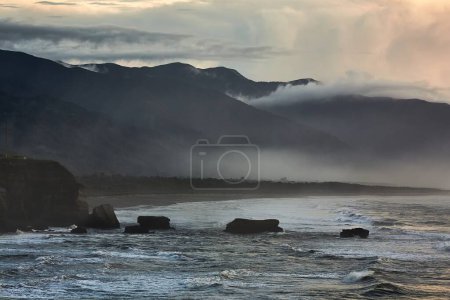 Photo for Beach in cloudy mist at Pancake Rocks, New Zealand South Island shores - Royalty Free Image