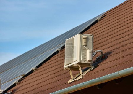 Exterior unit of an air conditioner on a house roof