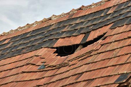 Photo for Damaged roof of an old village house - Royalty Free Image