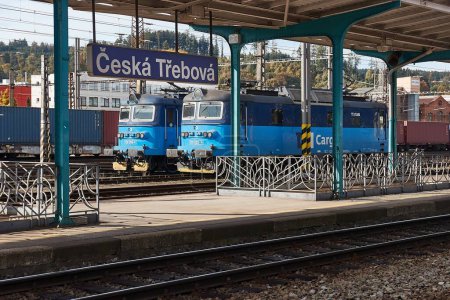 Photo for Ceska Trebova, Czchia - October 25, 2023: Railway station platforms sign, parked locomotives at train station along one of Czech Republics main railway lines. Engines of Ceske Drahy Cargo, CD Cargo - Royalty Free Image