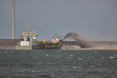 Dredging ship in the Port of Rotterdam, near Maasvlakte. Dredger vessel are used for reclaiming land, expanding the port area towards the North Sea