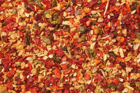 Photo for Spice mix for cooking dishes. Flakes of red hot pepper, paprika, garlic, onion. Dried seasoning background. - Royalty Free Image