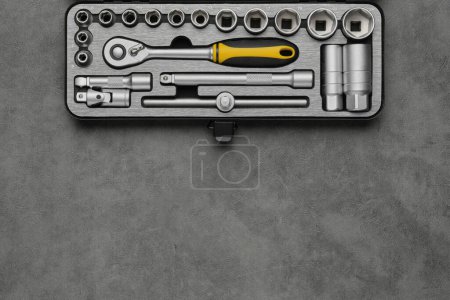 Photo for Tool kit for the car repair. Ratchet and bits tool kit. Socket wrench and ratchet heads. Equipment for auto mechanic on gray background. Tools for car repair at a service station. Top view, flat lay. - Royalty Free Image