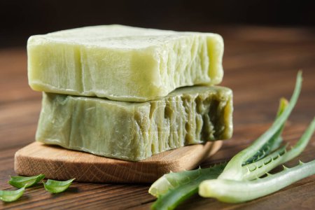 Photo for Organic aloe vera soap bars, Homemade natural soap and aloe leaves on a wooden board. - Royalty Free Image