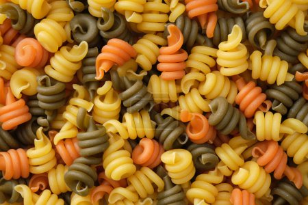 Photo for Spiral pasta background. Different colored pasta, top view, flat lay. - Royalty Free Image