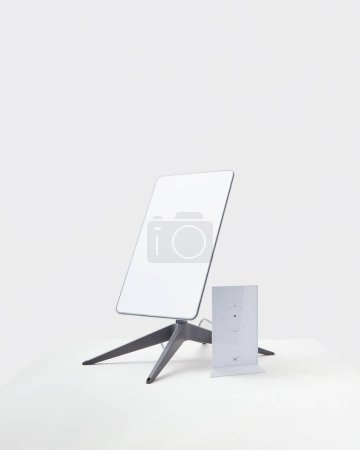 Photo for KYIV, UKRAINE - JANUARY 24, 2023: Starlink antenna and wi-fi router on white background. - Royalty Free Image