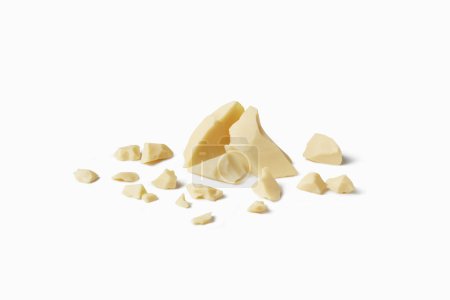 Photo for Chunks of homemade white chocolate on white backdrop with space for text. Natural snack. Minimal design. - Royalty Free Image
