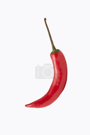 Photo for Red chili pepper in shape of crescent moon over white background. Natural flavor of sharp note to any dish. - Royalty Free Image
